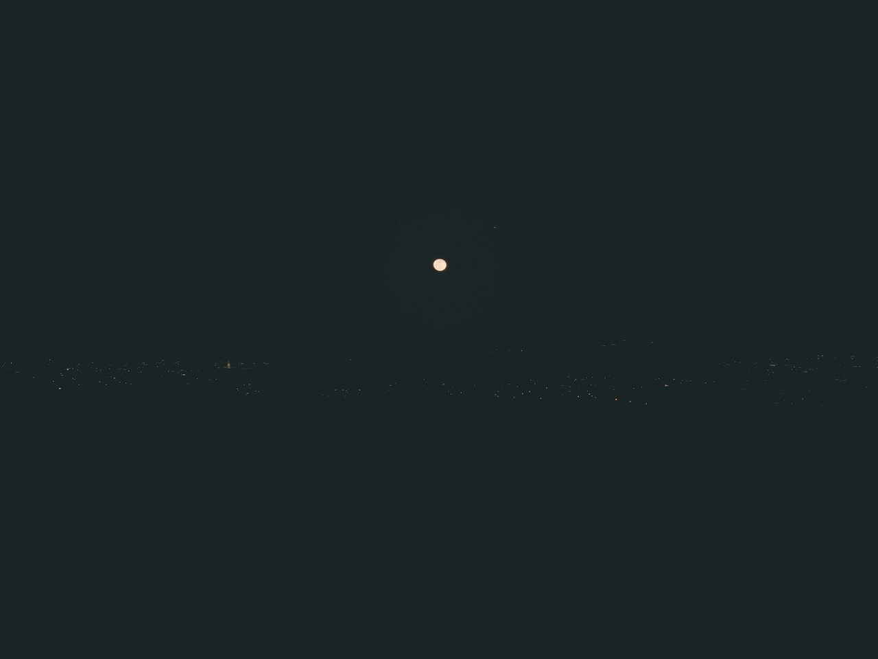 the moon appears in an empty sky