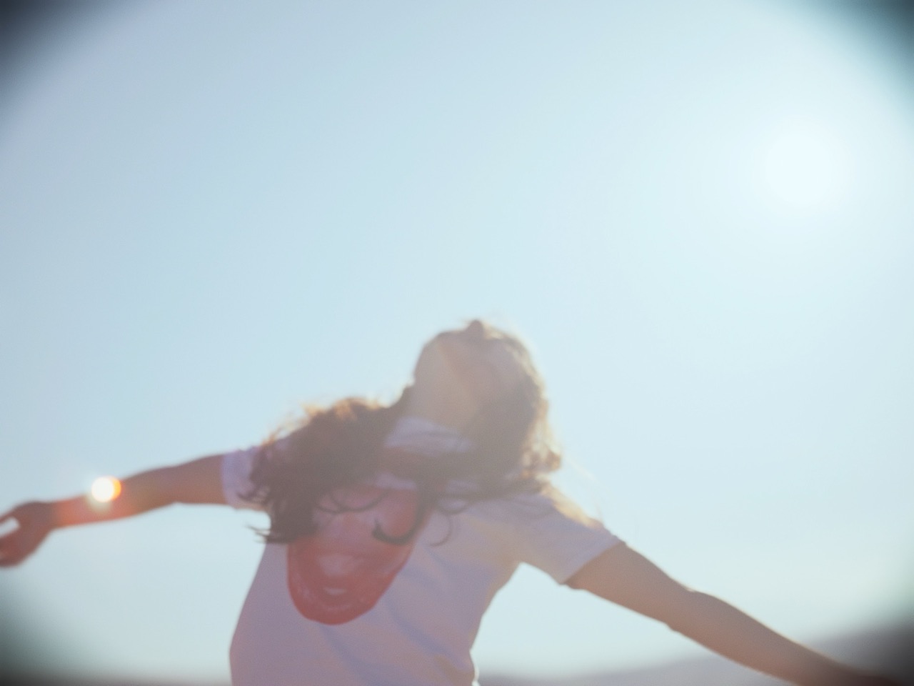 a young woman spins in a field
