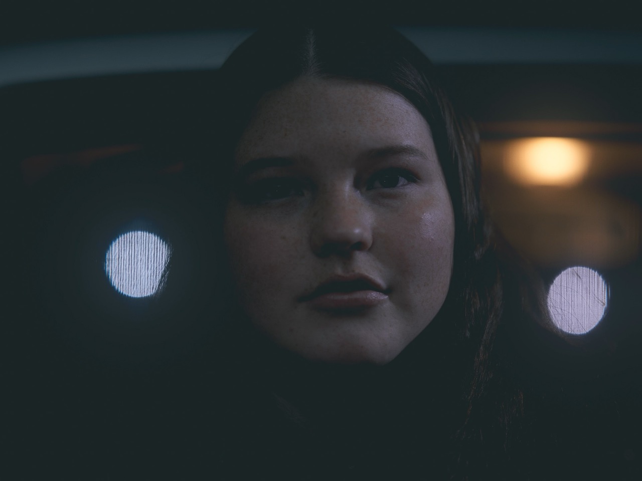 a young woman looks into the camera