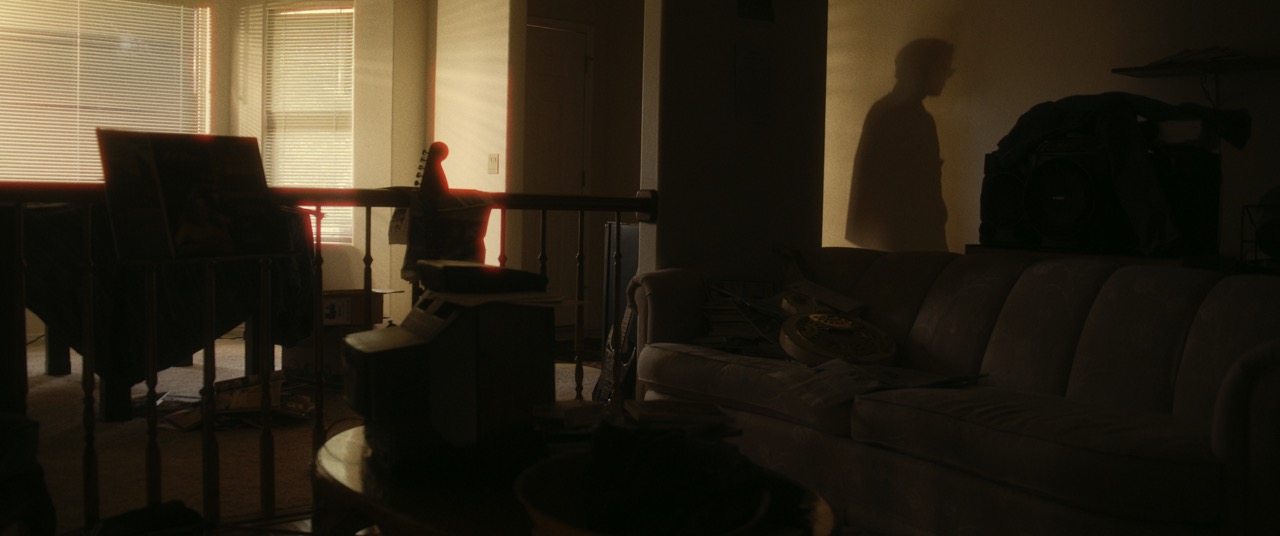 a mans silhouette appears in the doorway