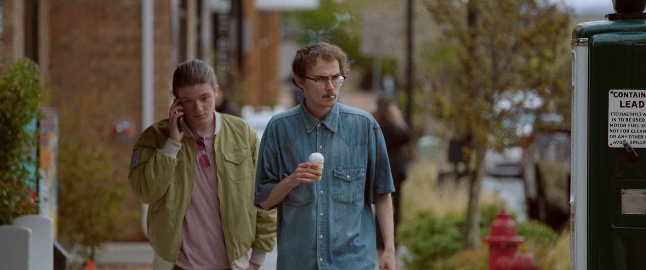 a man walks down a street holding icecream