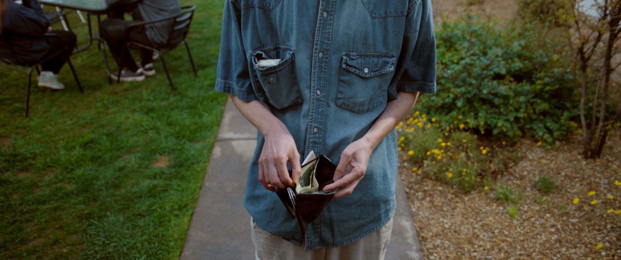 a man looks through his wallet