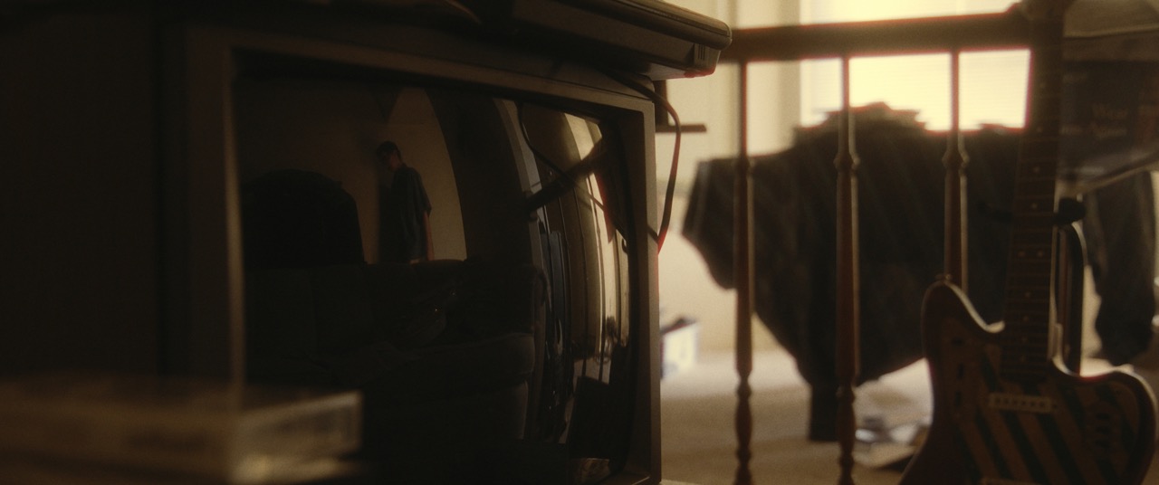 a reflection appears on a tv in a dark room