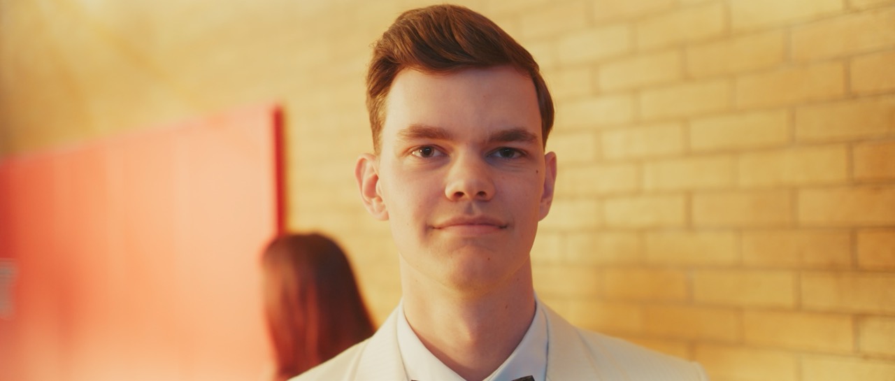 a man looks longingly towards the camera