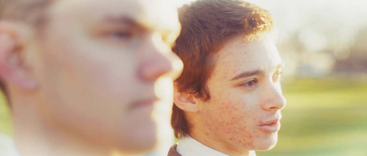 two men look intently off into the distance