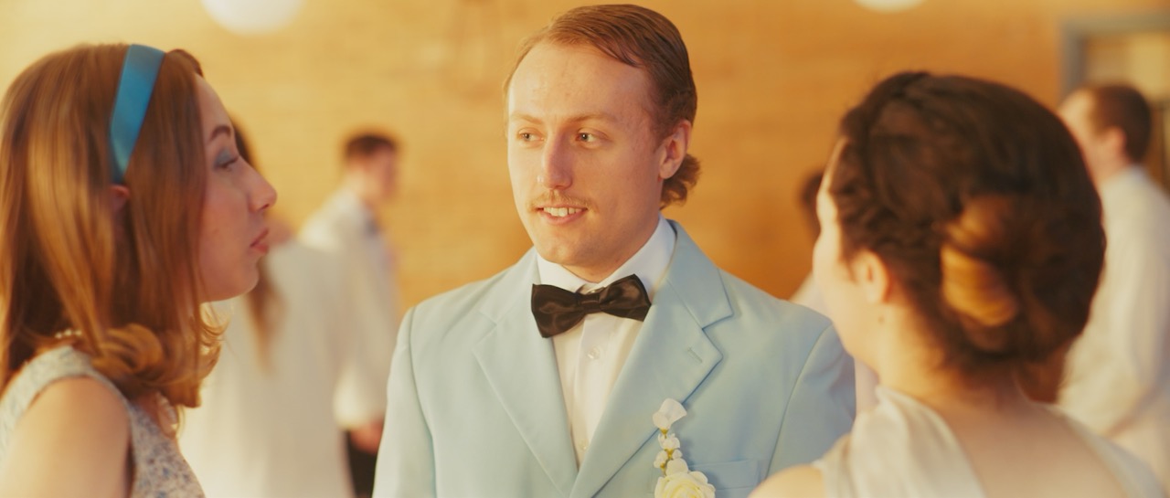 a group of people are talking in prom attire