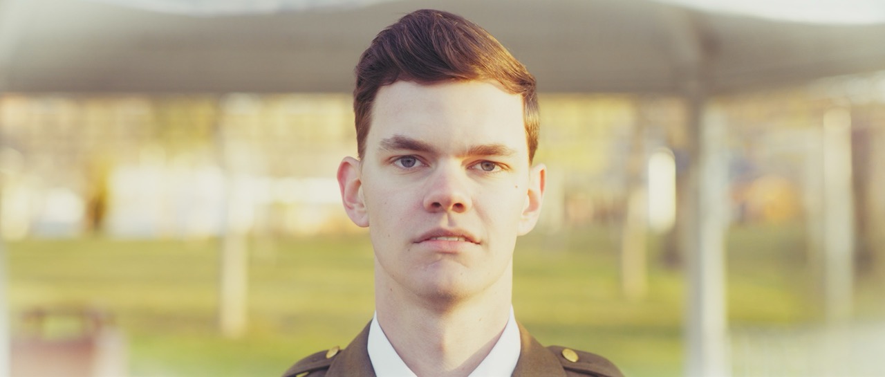 a man looks longingly into the camera