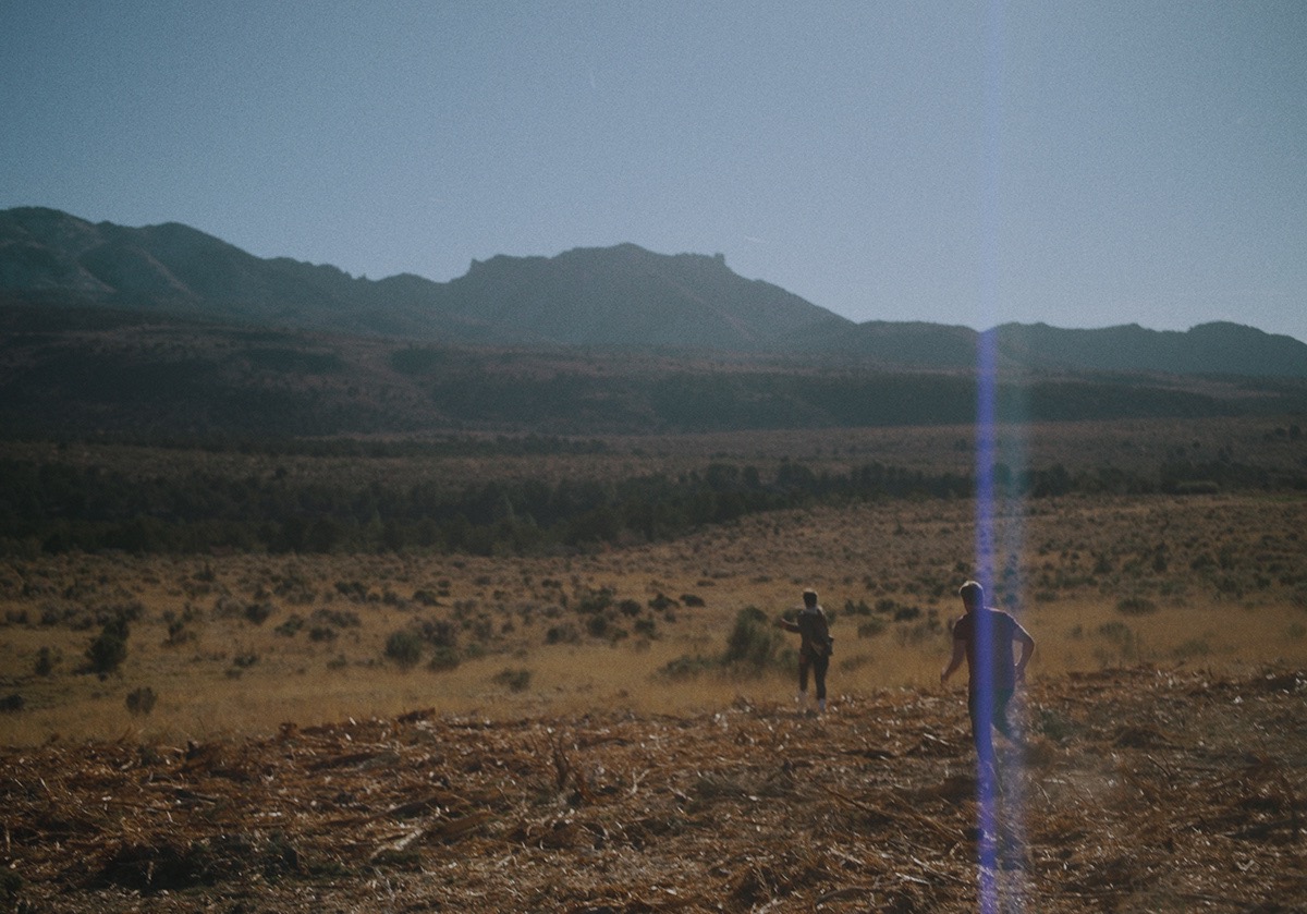 two boys run off into a field