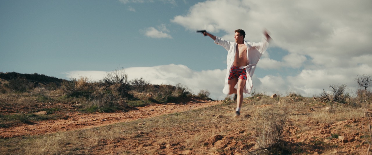 two friends running down a desert hill