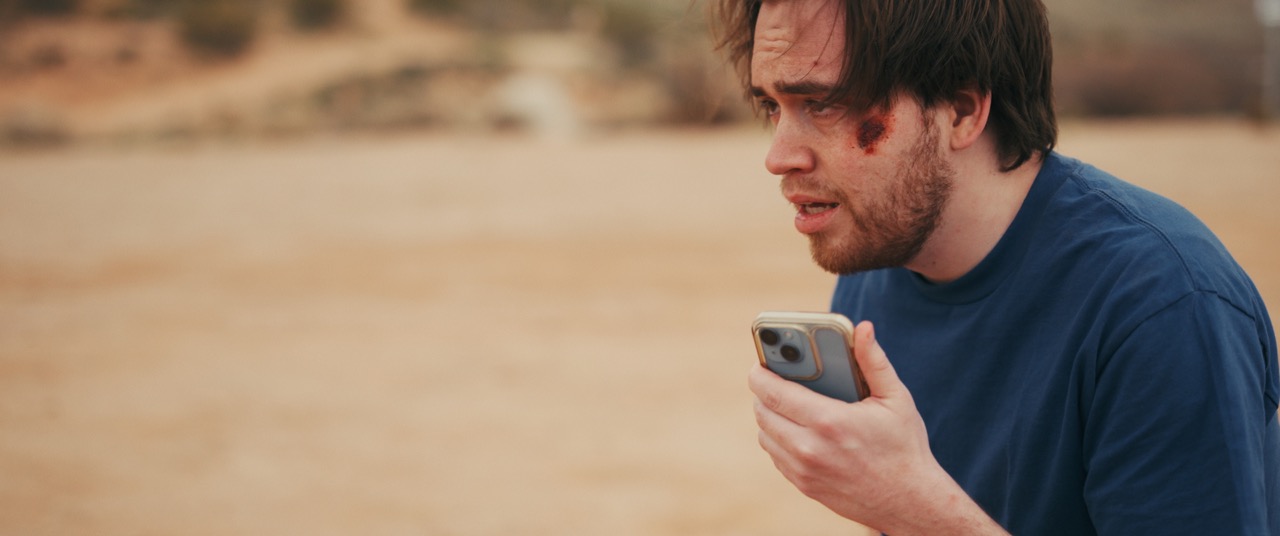 a man is sorrowful as he holds a phone