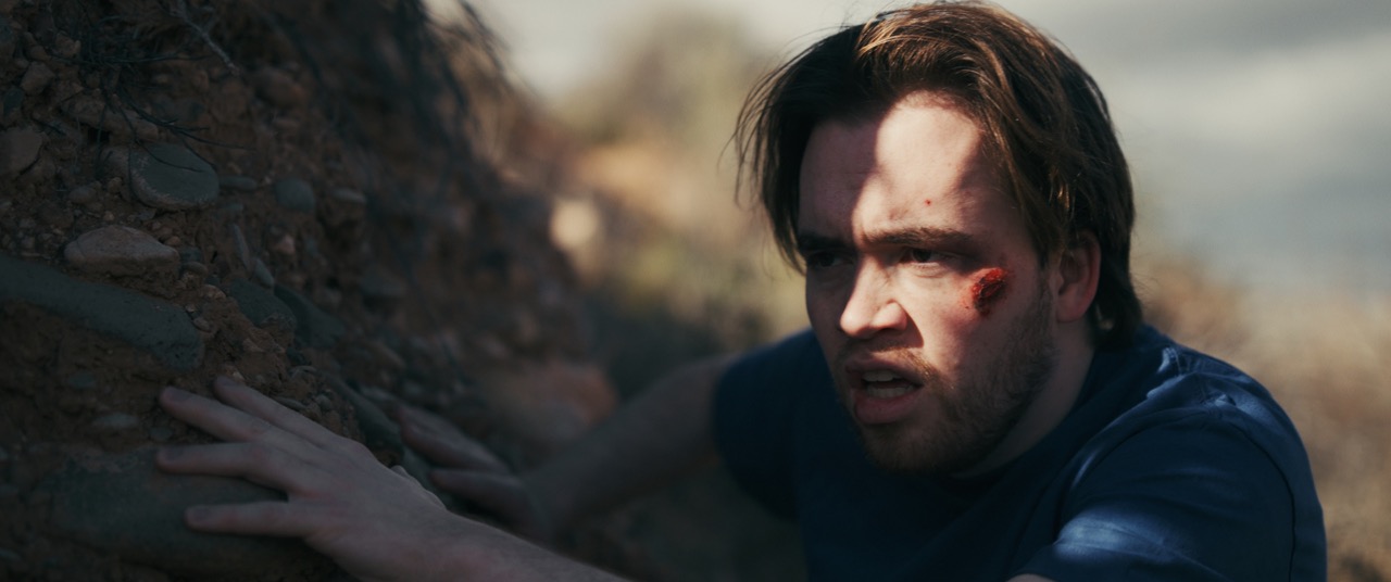 a man is obscured by shadow in a desert