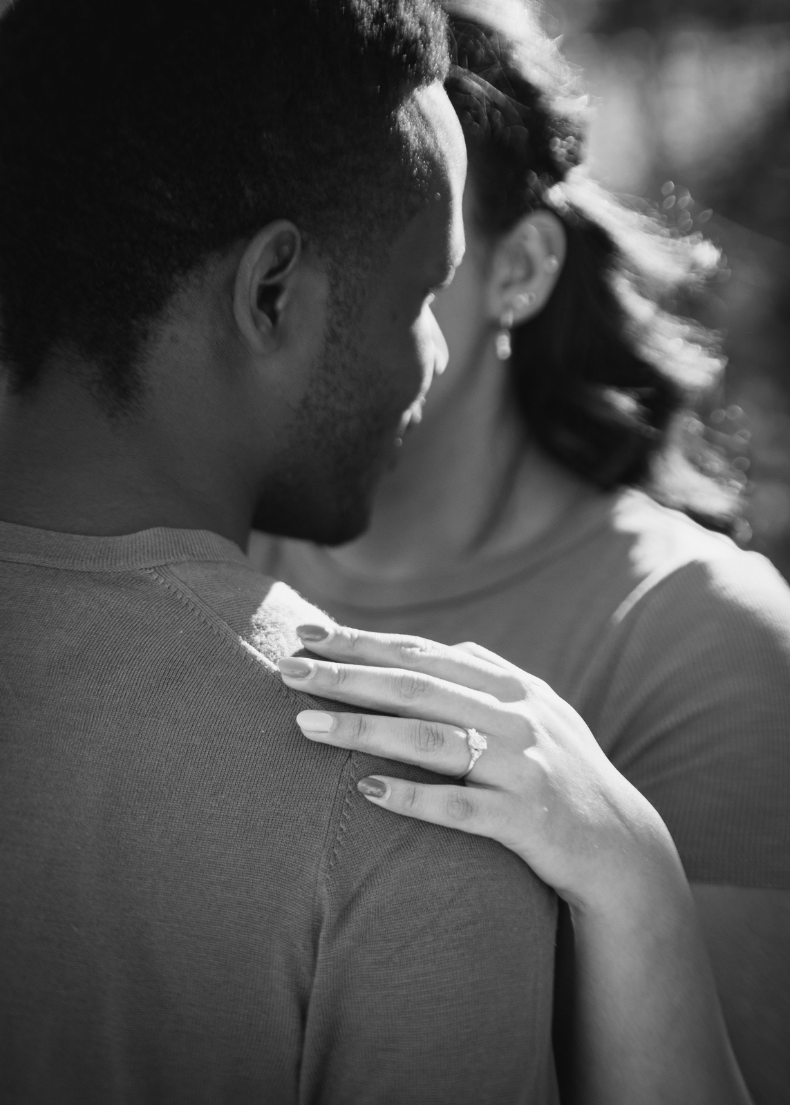 black and white couples engagement photos showing a ring