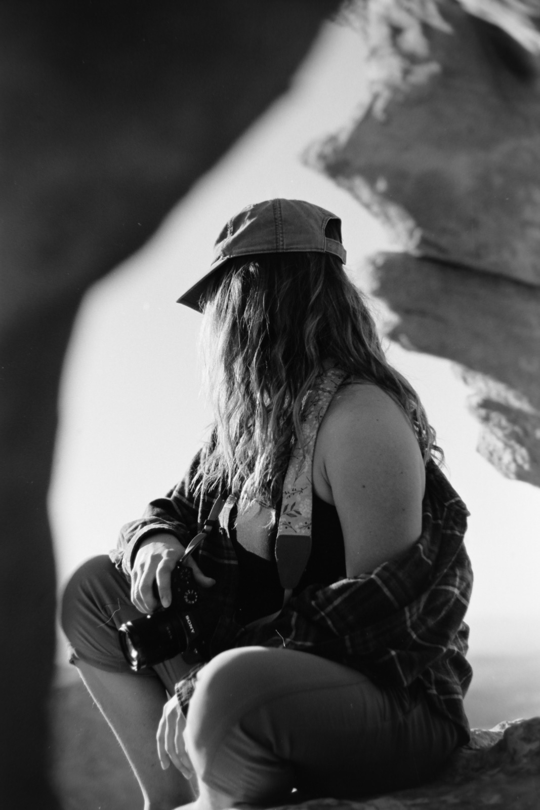 a woman appears to be surrounded by stone on all sides, black and white