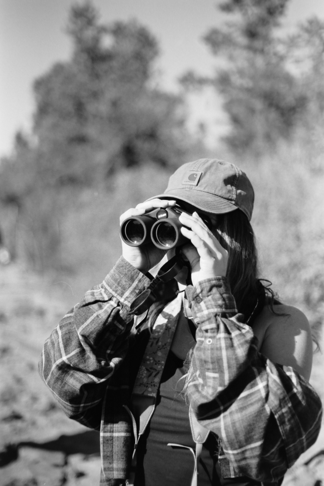 black and white portrait of a girl with binoculars