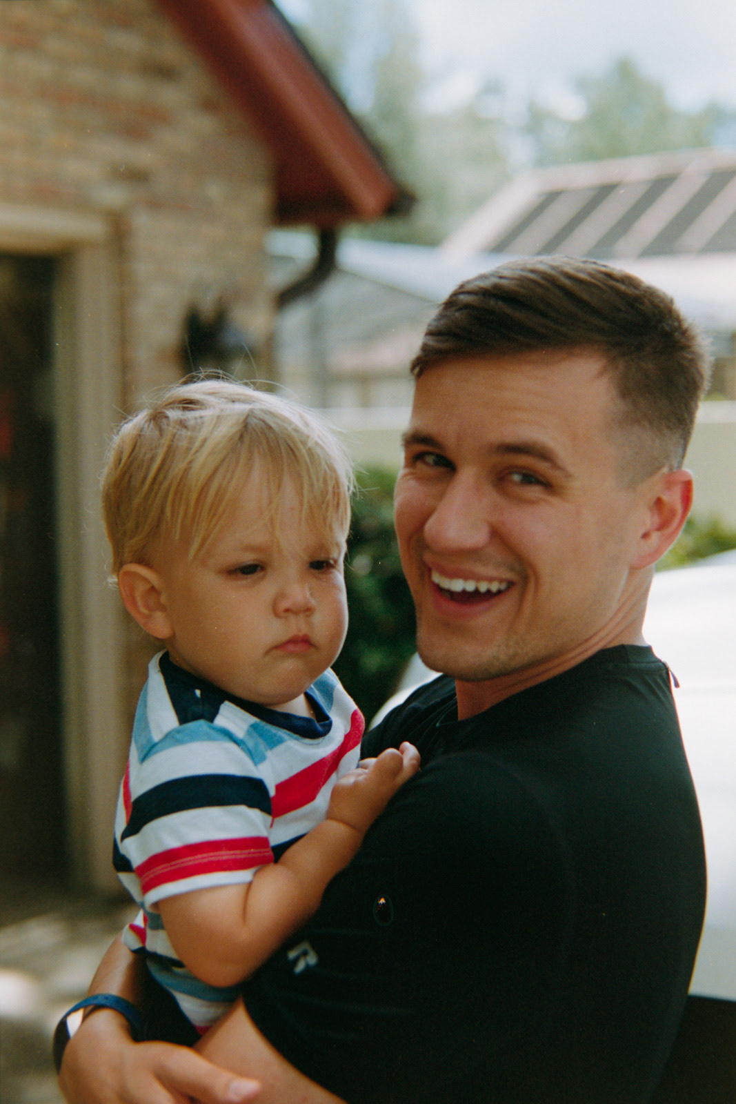 film photo of a dad holding his young son